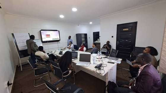 The mission debrief session at the AIC office, presenting preliminary findings and recommendations.